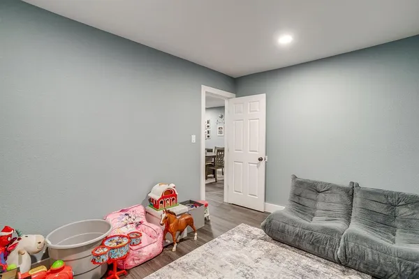 a bedroom with furniture and a wooden floor