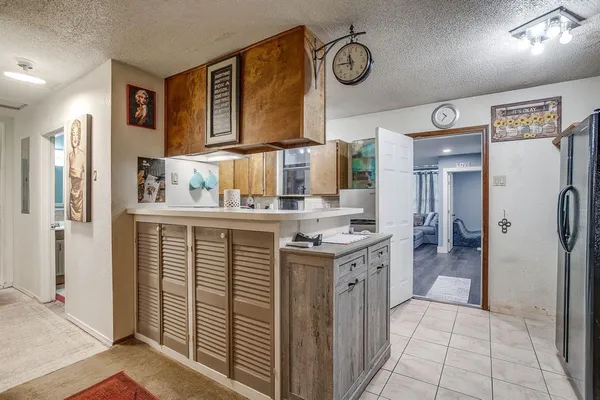 a kitchen with stainless steel appliances granite countertop a refrigerator and a stove