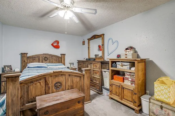 a bedroom with furniture and a chandelier
