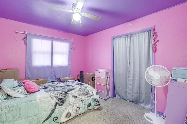 a bedroom with a bed and dresser