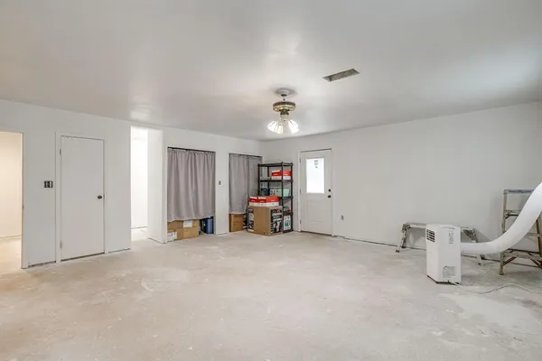 a view of empty room with furniture and ceiling fan