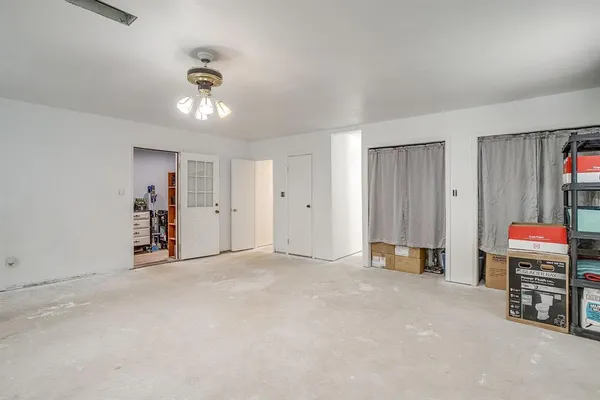 an empty room with a projector and furniture