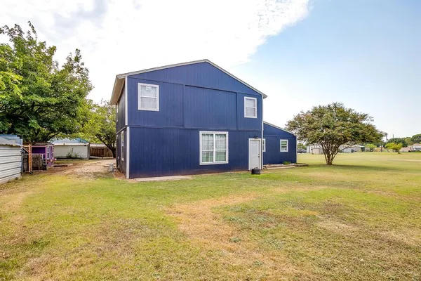a view of a house with a yard and garage