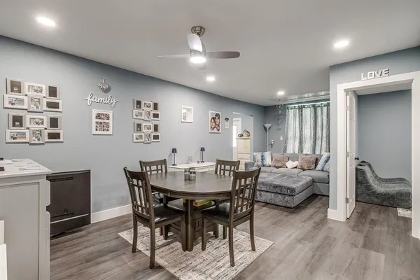 a view of a dining room with furniture and wooden floor