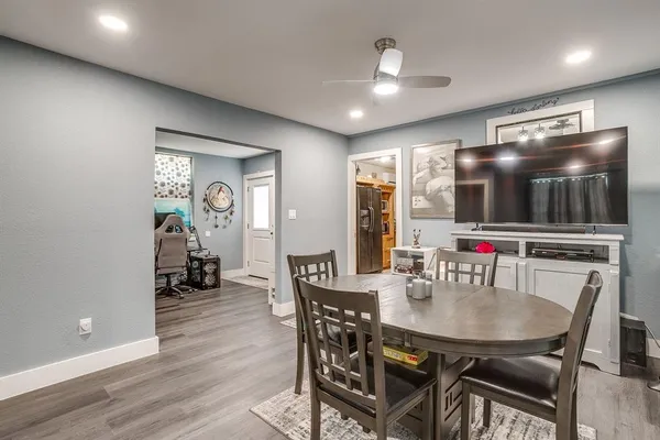 a view of a dining room with furniture and wooden floor