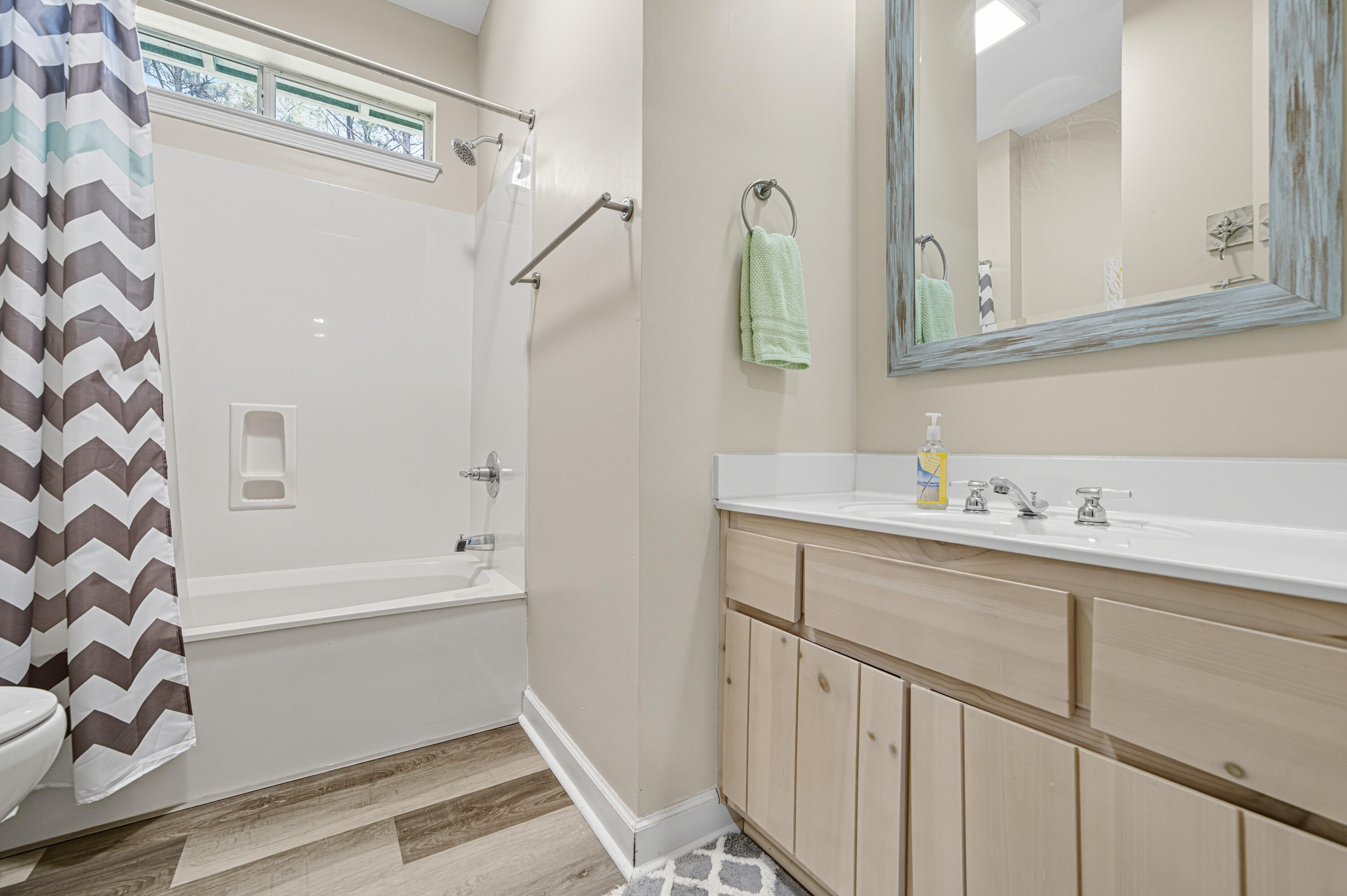 8 Corte Palma, Unit 61A Santa Rosa Beach, FL 32459 - Photo 17 of 32 a bathroom with a sink a mirror a vanity and a bathtub