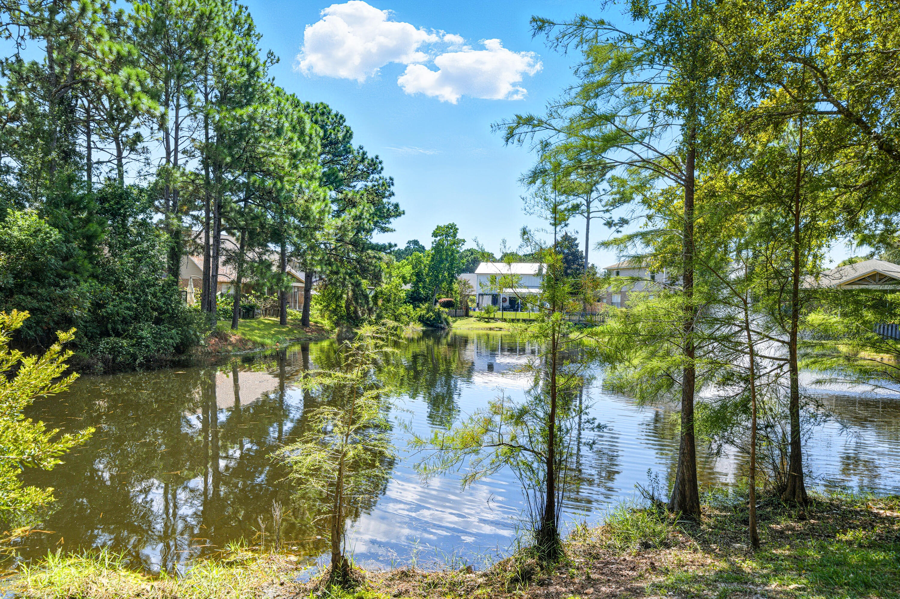 8 Corte Palma, Unit 61A Santa Rosa Beach, FL 32459 - Photo 22 of 32 a backyard of a house with lots of green space and fountain