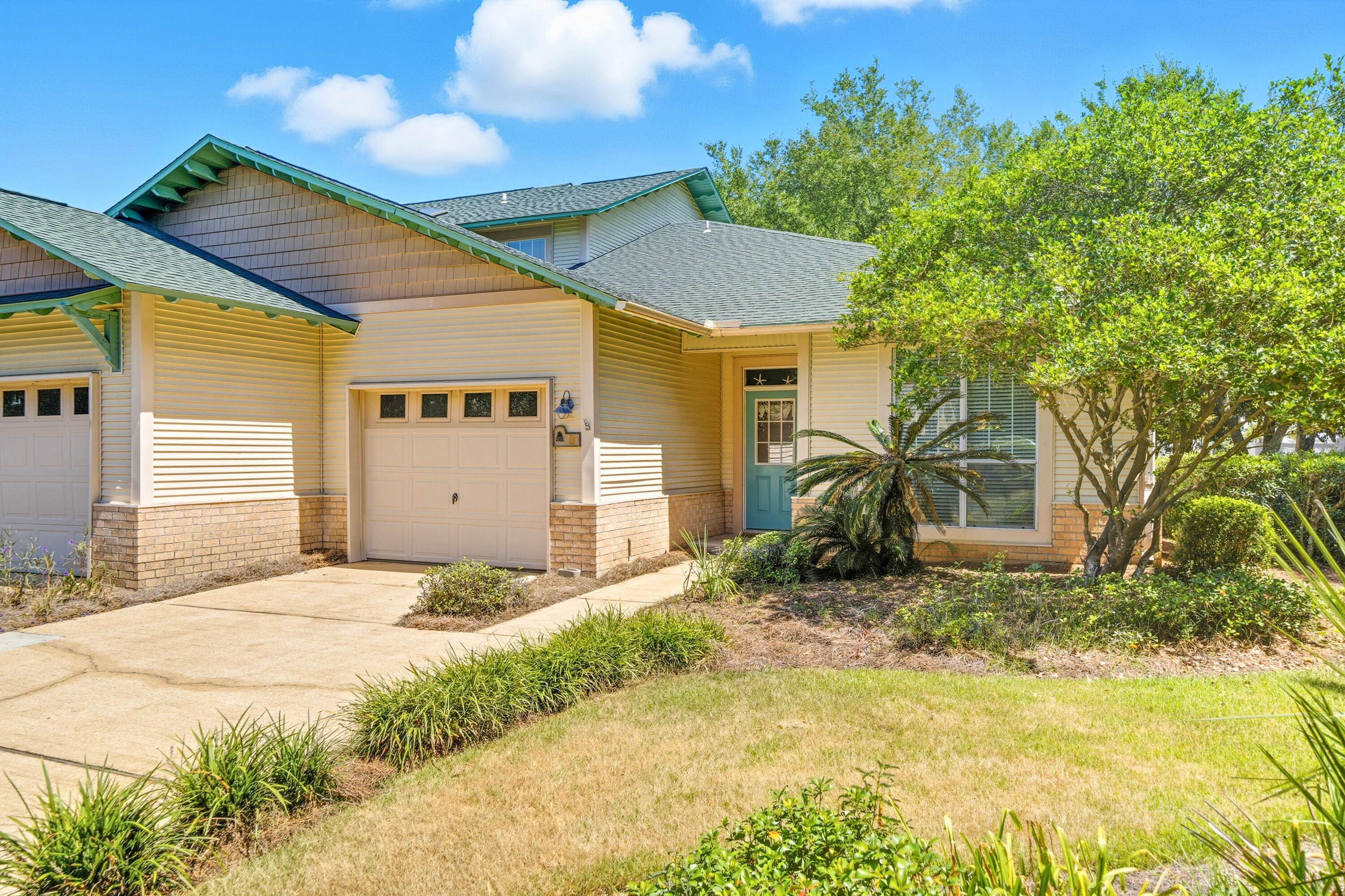 8 Corte Palma, Unit 61A Santa Rosa Beach, FL 32459 - Photo 3 of 32 a front view of a house with a yard and garage
