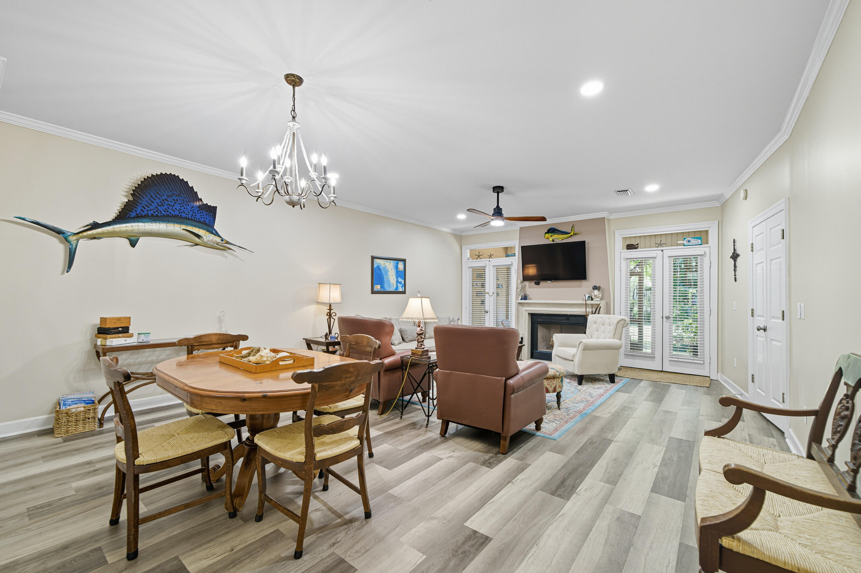 8 Corte Palma, Unit 61A Santa Rosa Beach, FL 32459 - Photo 5 of 32 a view of a dining room with furniture a chandelier and wooden floor