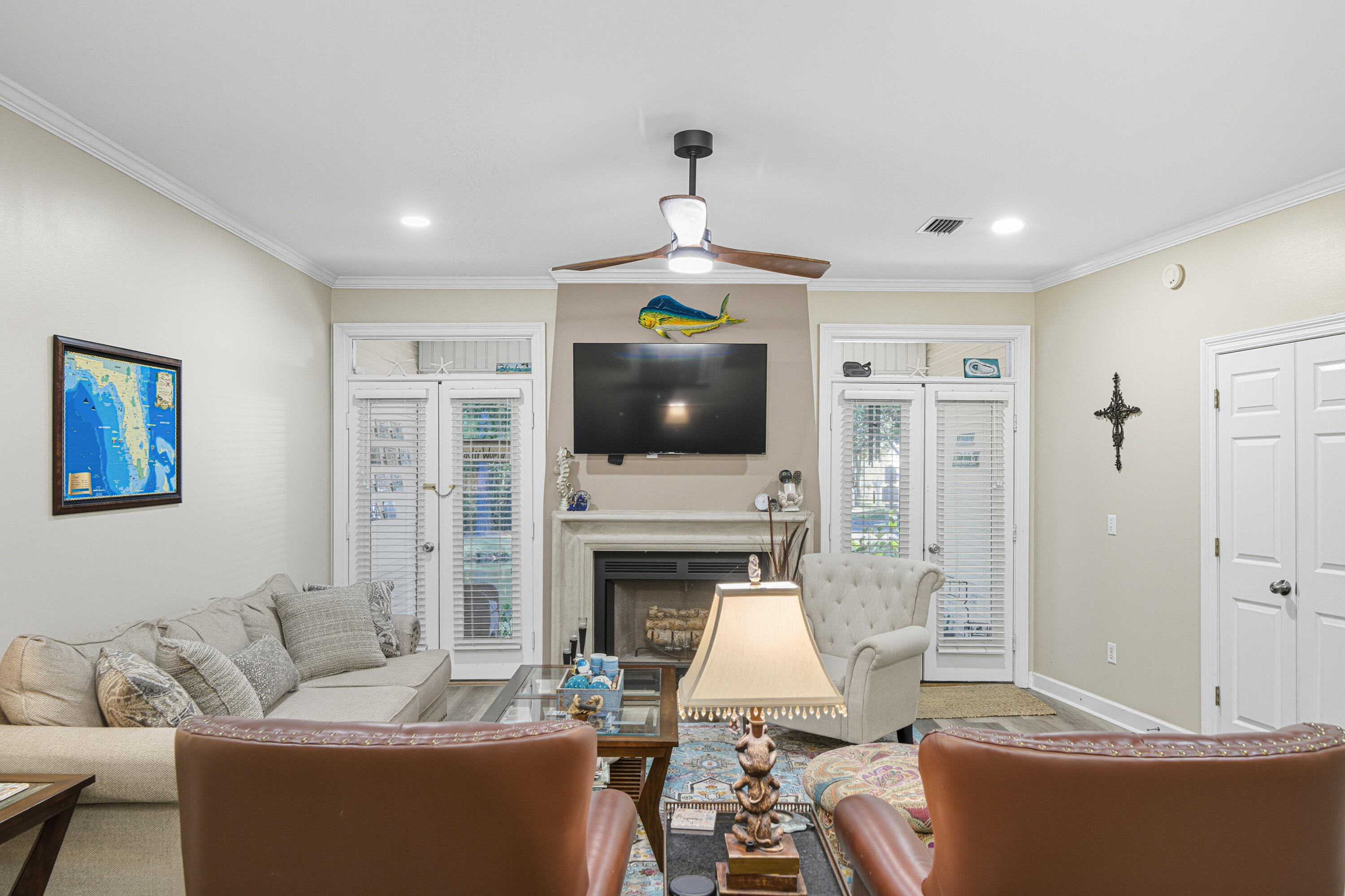 8 Corte Palma, Unit 61A Santa Rosa Beach, FL 32459 - Photo 6 of 32 a living room with furniture a flat screen tv and a fireplace