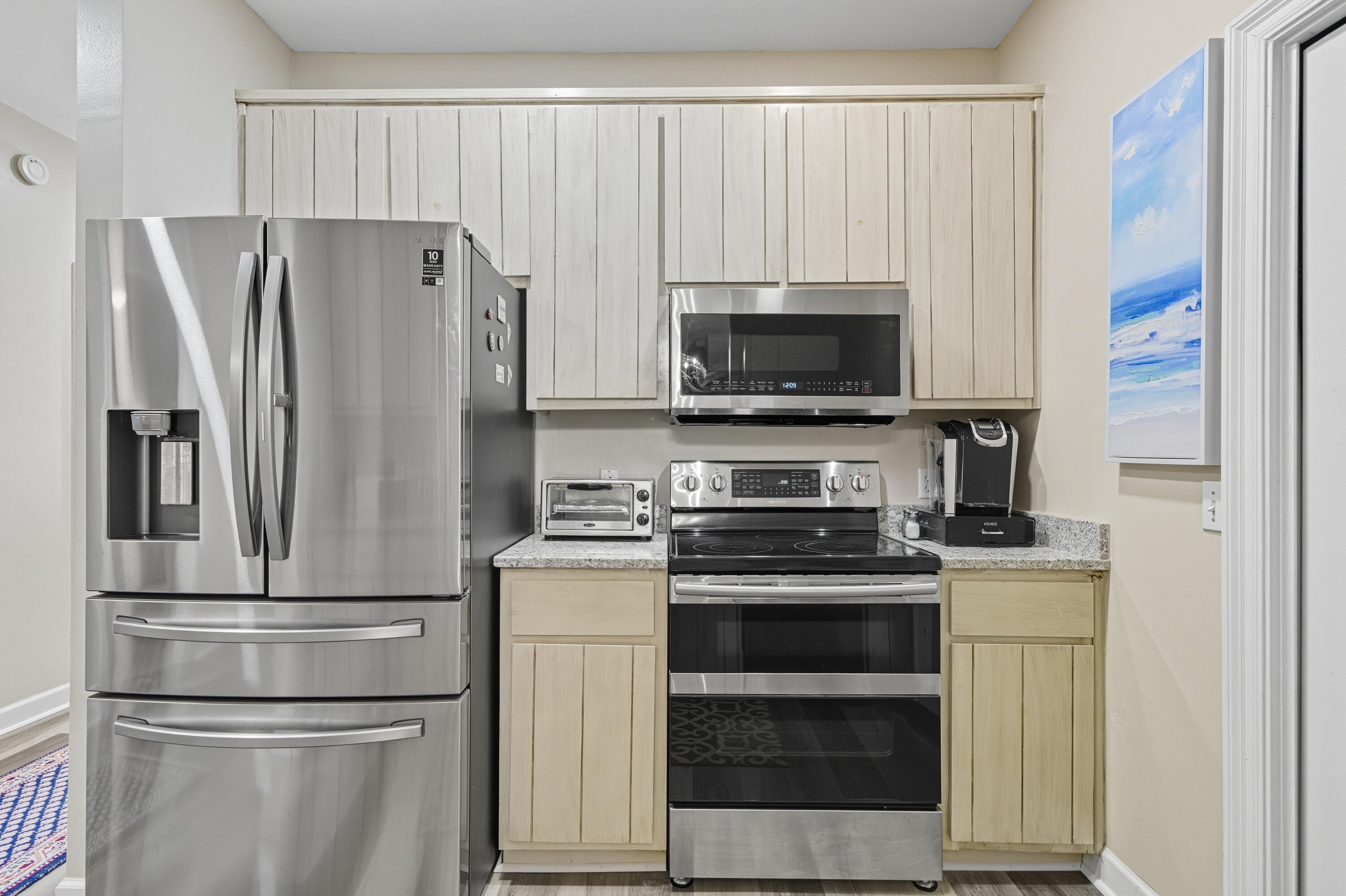 8 Corte Palma, Unit 61A Santa Rosa Beach, FL 32459 - Photo 9 of 32 a kitchen with appliances a refrigerator and a window