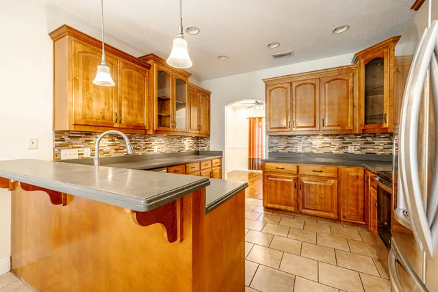 a kitchen with stainless steel appliances granite countertop a sink and cabinets