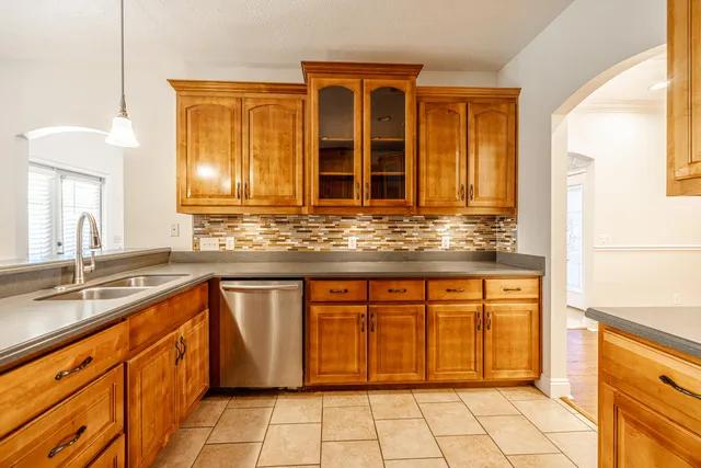 a kitchen with stainless steel appliances granite countertop a sink and cabinets