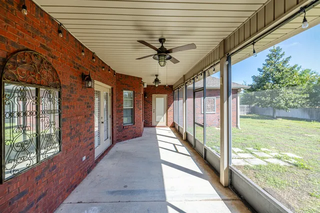 a view of a porch with a table and chairs