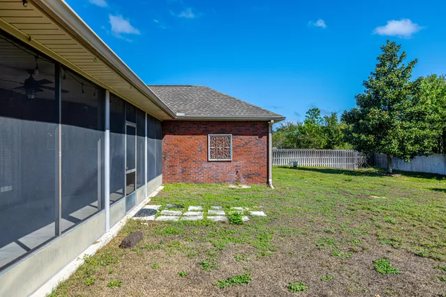 a view of a house with a yard and potted plants