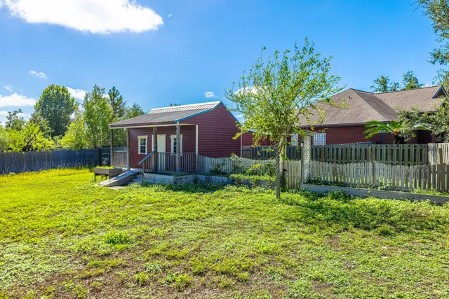 a backyard of a house with table and chairs