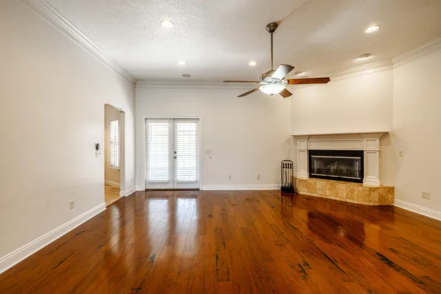 a view of an empty room with a fireplace and a window