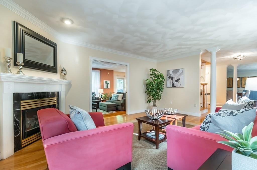 63 Rattlesnake Hill Road Andover, MA 01810 - Photo 4 of 40 a living room with furniture a flat screen tv and potted plant