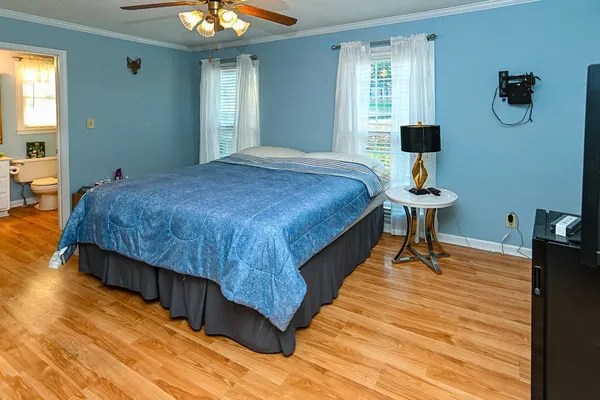 a bed sitting in a bedroom next to a window