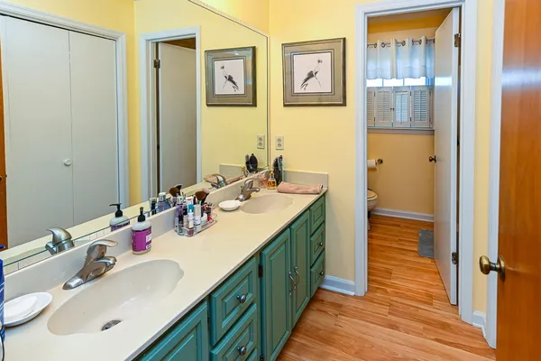 a bathroom with a double vanity sink and a mirror