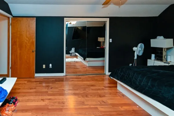 a bedroom with bed and a window