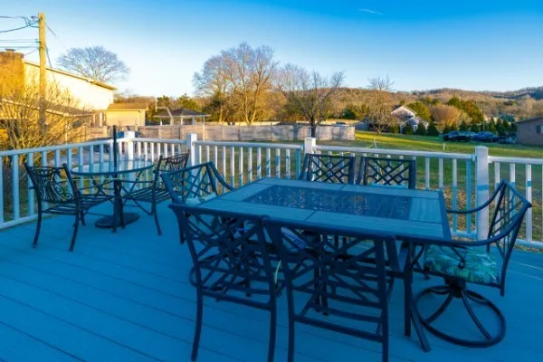 a view of a chairs and table on the roof deck