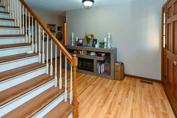 a view of entryway and hall with wooden floor