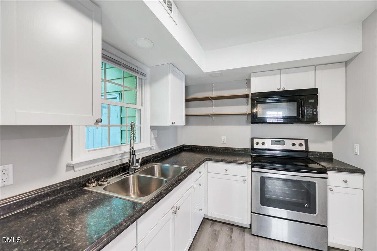 3408 Atlantic Avenue Raleigh, NC 27604 - Photo 30 of 48 a kitchen with granite countertop a sink and steel appliances