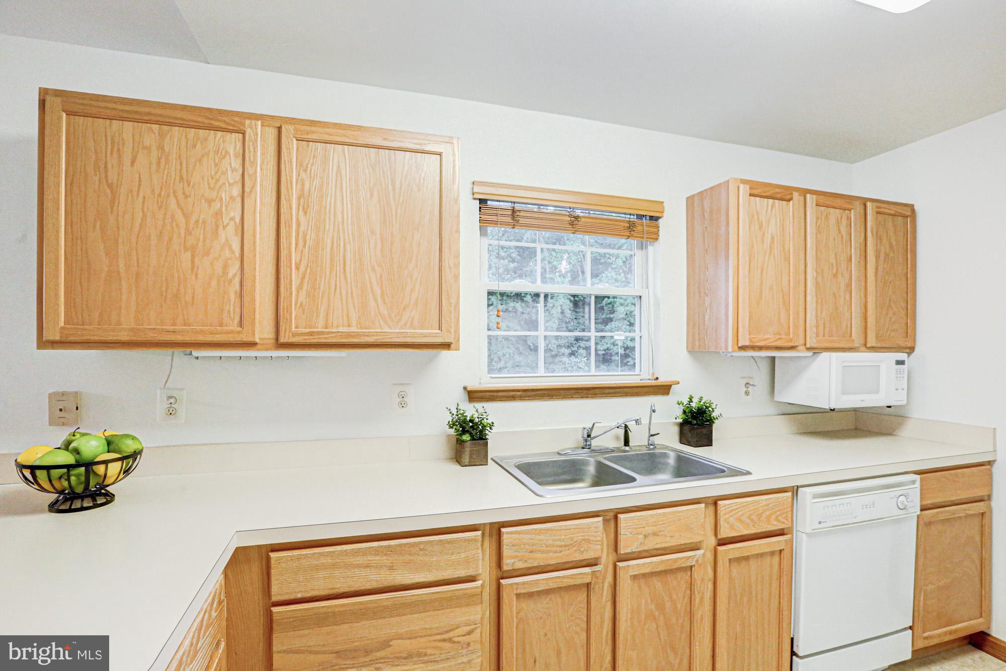 230 Tina Marie Lane Smyrna, DE 19977 - Photo 32 of 83 a kitchen with stainless steel appliances granite countertop white cabinets a sink and a window