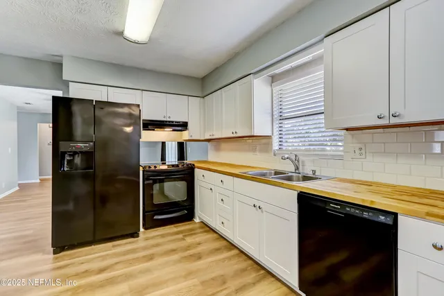 a kitchen with a sink stainless steel appliances and cabinets
