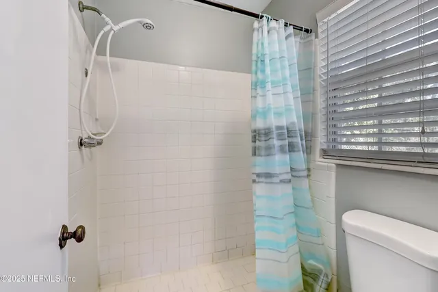 a bathroom with a shower and a toilet