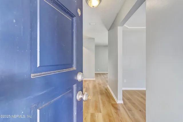 a view of a room with wooden floor