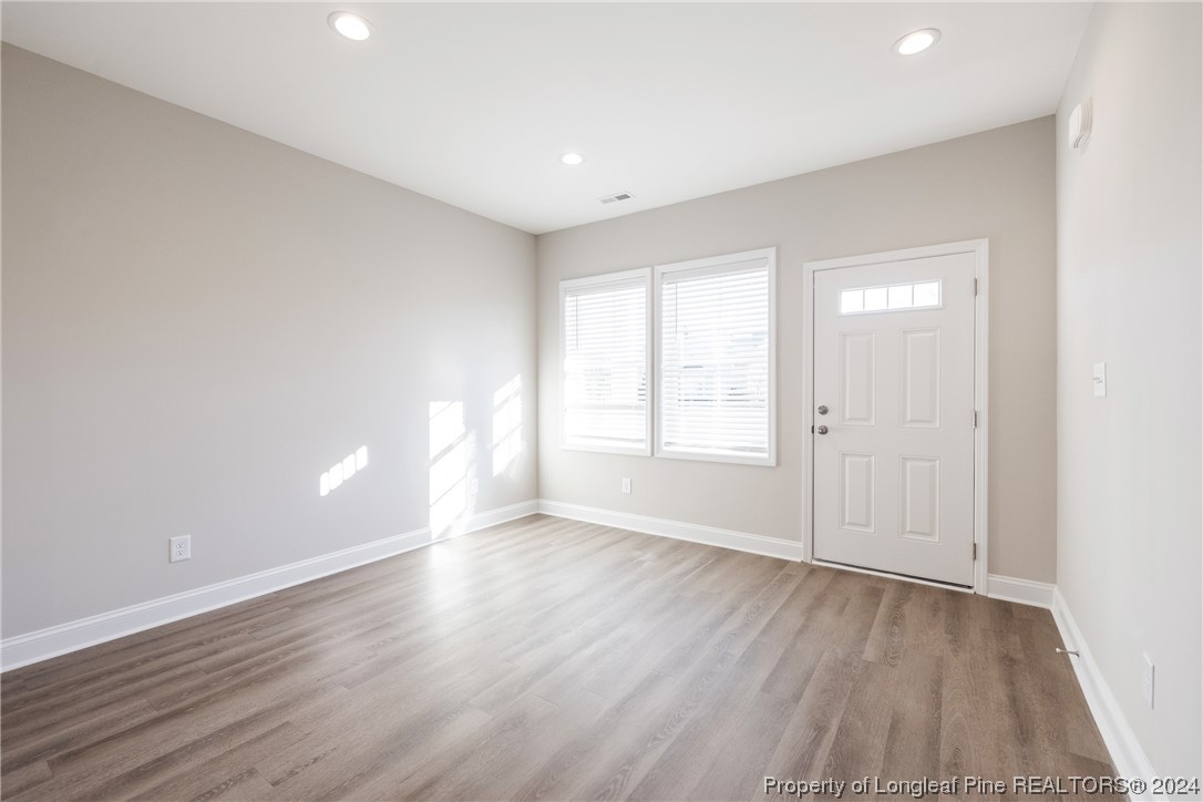 908 Westland Ridge Road Fayetteville, NC 28311 - Photo 3 of 28 a view of an empty room with wooden floor and a window