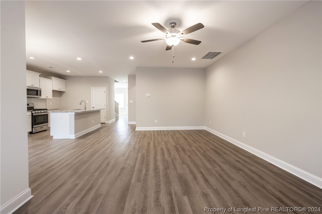 908 Westland Ridge Road Fayetteville, NC 28311 - Photo 7 of 28 a view of an empty room with wooden floor and a window