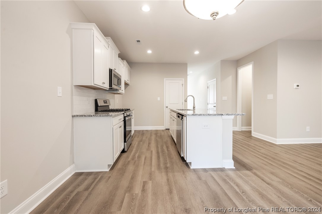 908 Westland Ridge Road Fayetteville, NC 28311 - Photo 9 of 28 a view of kitchen with wooden floor