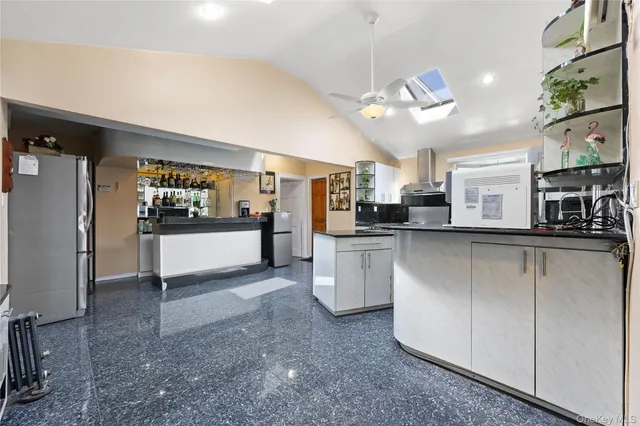 a kitchen with counter top space cabinets and appliances