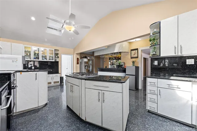 a kitchen with stainless steel appliances granite countertop a sink and cabinets