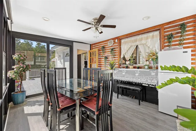 a dining room with furniture water view and a floor to ceiling window