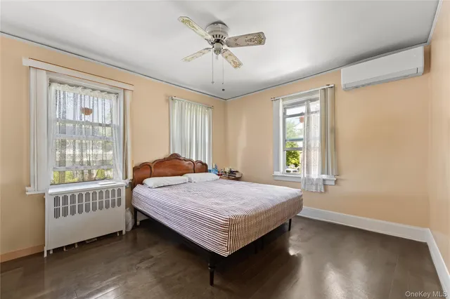 a bed sitting in a spacious bedroom next to a window