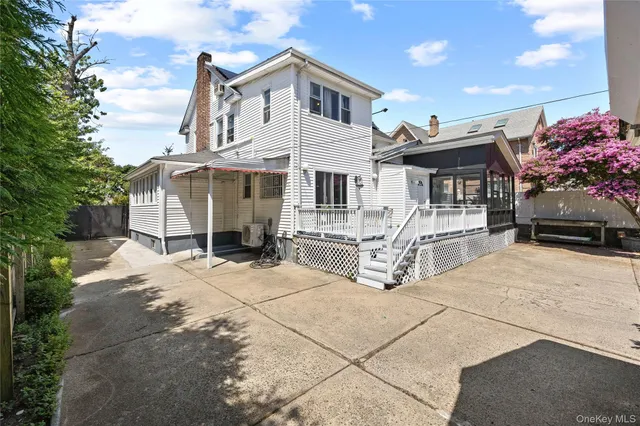 a view of house with yard and sitting area