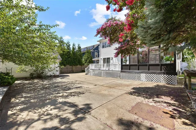 a tree lined with flowers on a sidewalk