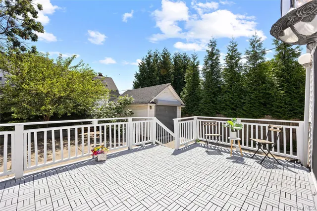 a terrace view with two chairs and a table
