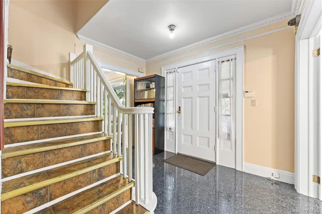 a view of entryway with wooden floor and front door