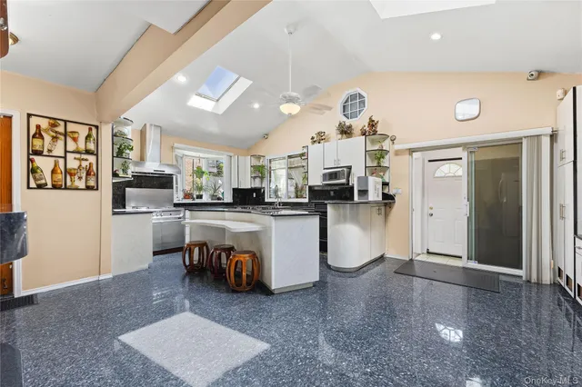 a living room with furniture and kitchen view