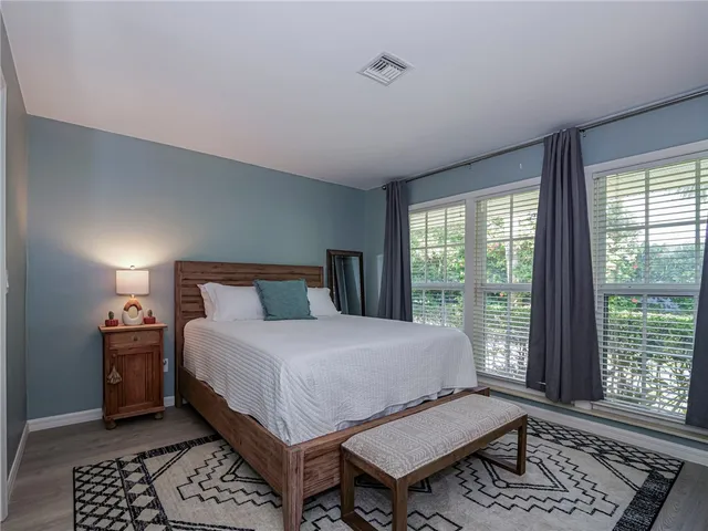 a bedroom with two beds and a large window