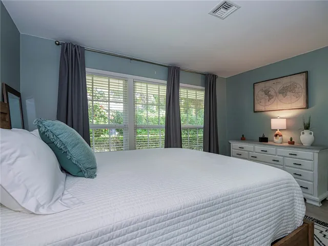 a bedroom with two beds and a large window