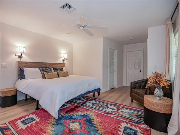 an aerial view of residential house with parking space and trees all around