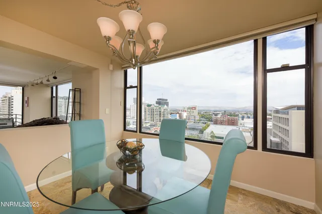 a dining room with furniture a chandelier and wooden floor