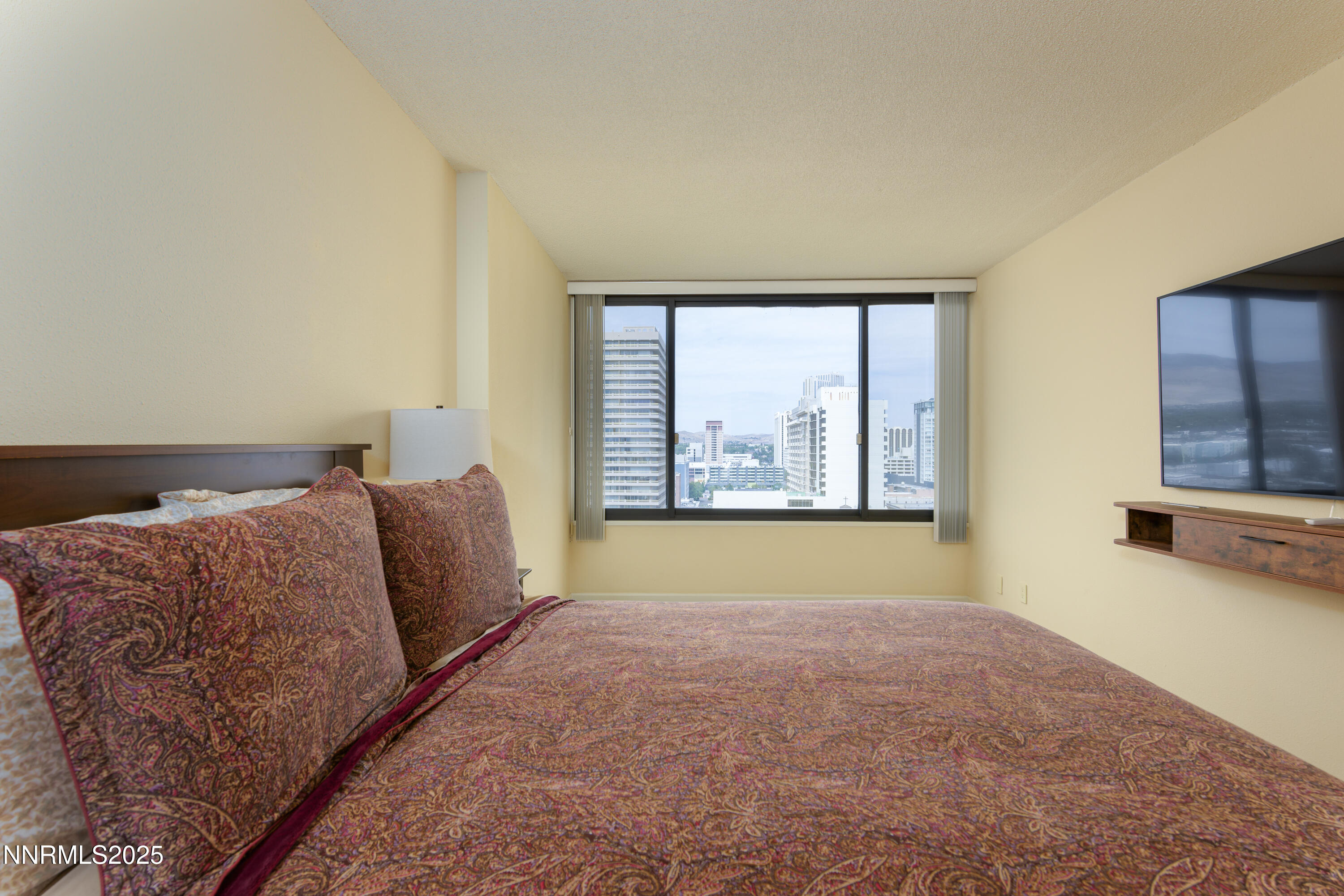 280 Island Avenue, Unit 1602 Reno, NV 89501 - Photo 19 of 35 a bed sitting in a room next to a window