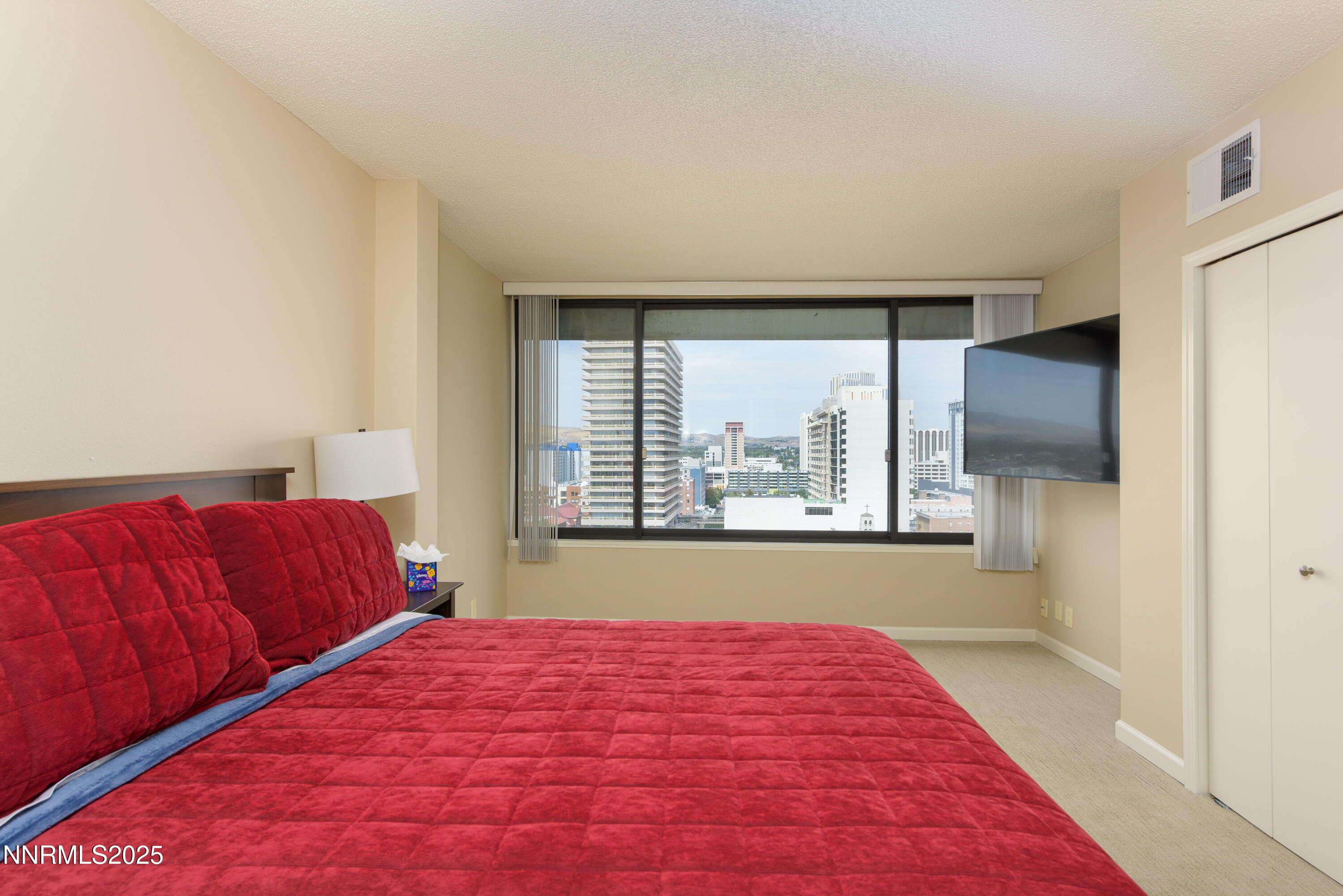 280 Island Avenue, Unit 1602 Reno, NV 89501 - Photo 25 of 35 a bedroom with a large bed and a window